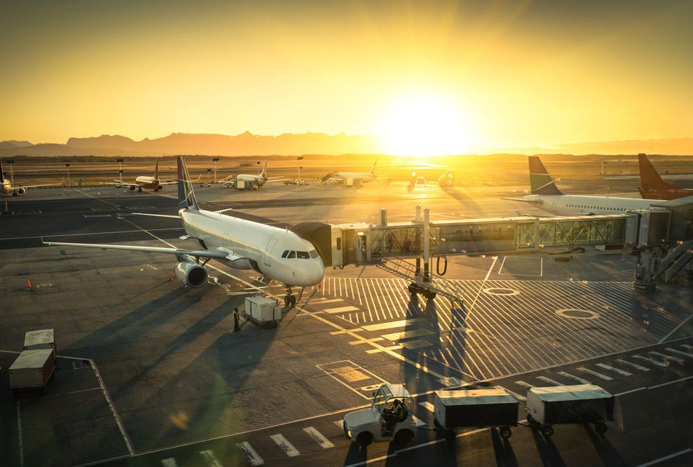 Airplane Parked at an Airport Terminal — Dave's Drive U Anywhere 24/7 Mini Van Hire In Wollongong, NSW