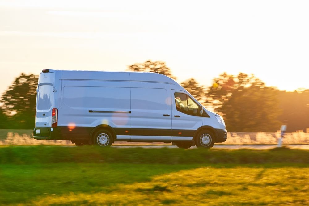 White Cargo Van Driving on Road — Dave's Drive U Anywhere 24/7 Mini Van Hire In Kiama, NSW