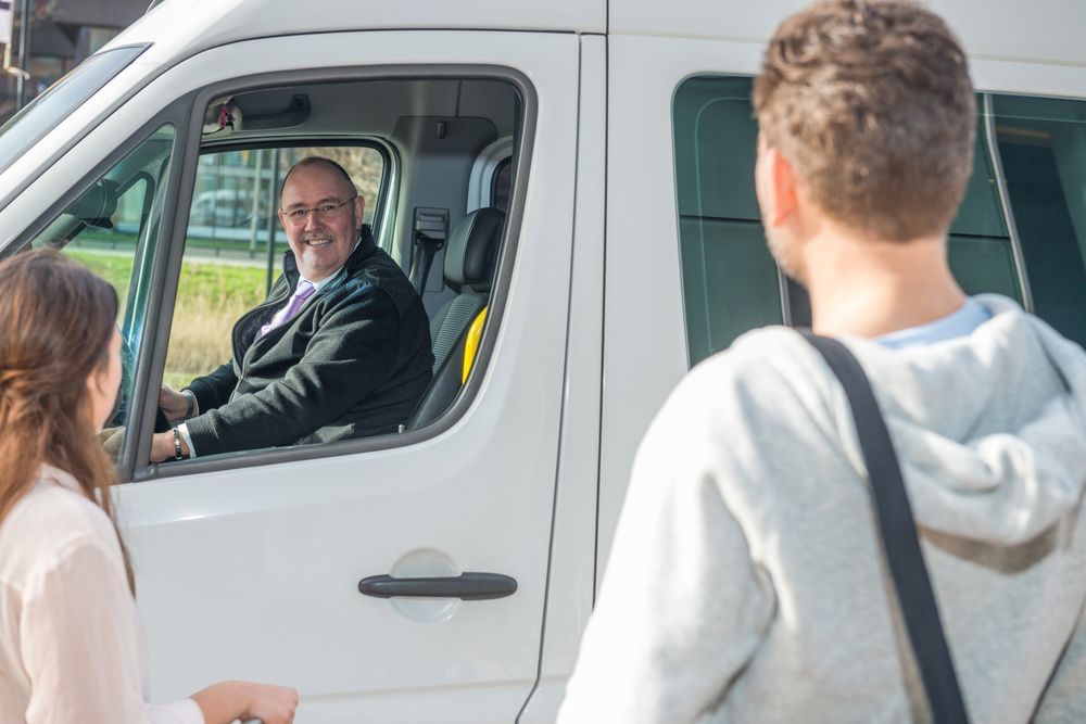 Man Smiling in a Van — Dave's Drive U Anywhere 24/7 Mini Van Hire In Wollongong, NSW