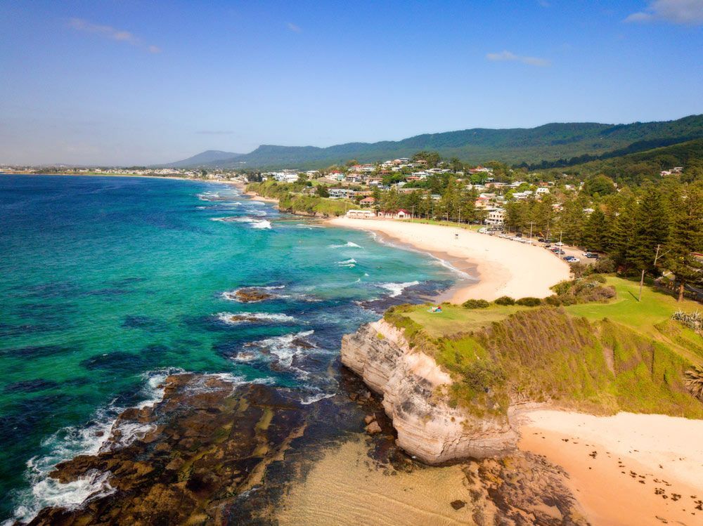 A View of A Beach with A City in The Background — Daves Drive U Anywhere in Austinmer, NSW