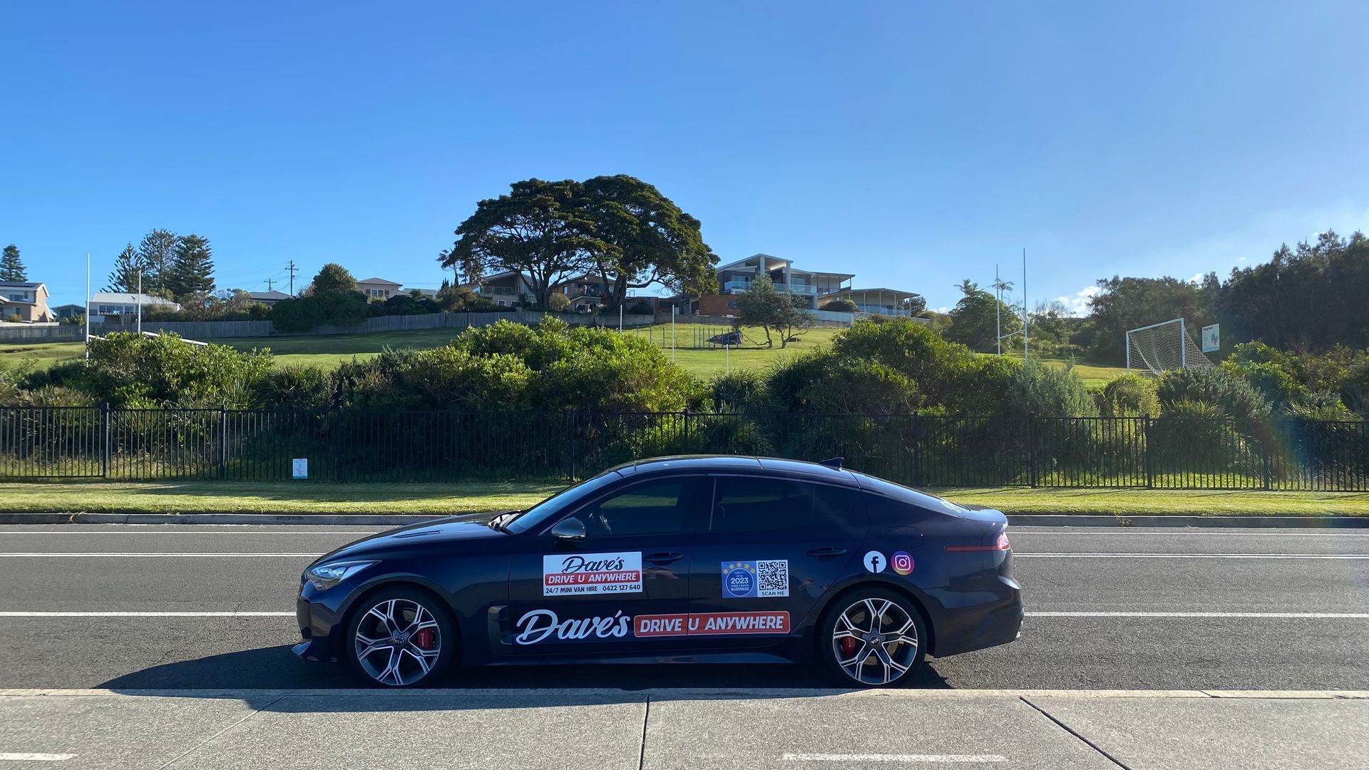 Dark Blue Car Parked on a Road — Dave's Drive U Anywhere 24/7 Mini Van Hire In Wollongong, NSW