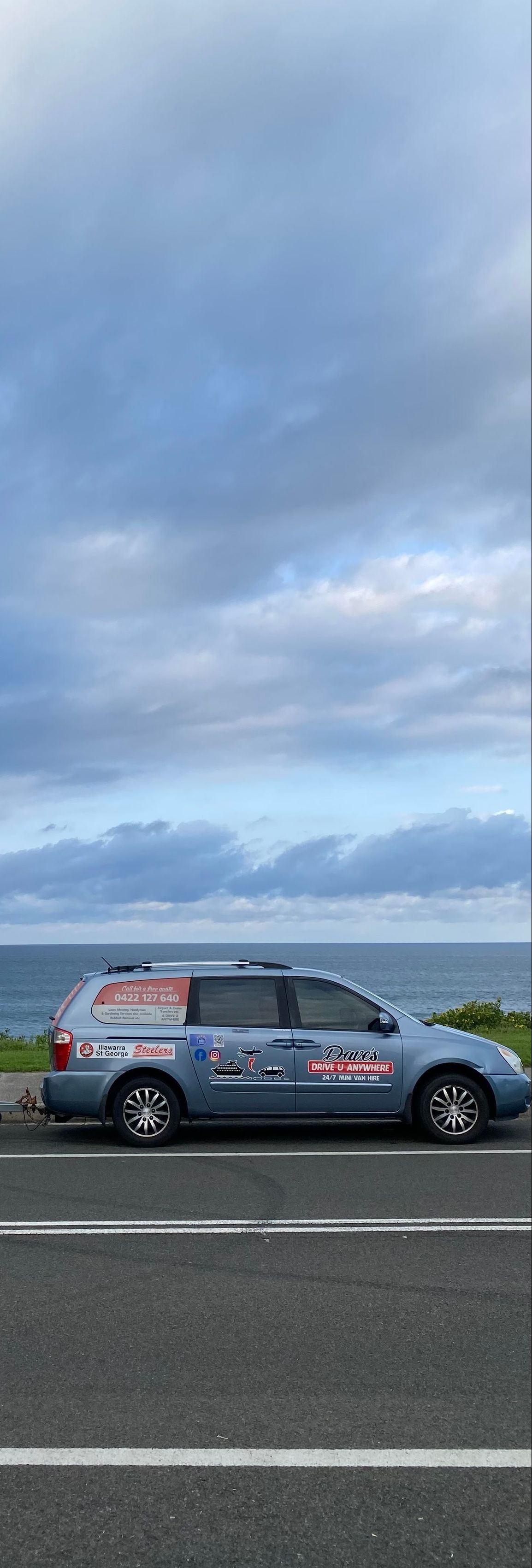 A Blue Car Parked on a Road — Dave's Drive U Anywhere 24/7 Mini Van Hire In Austinmer, NSW