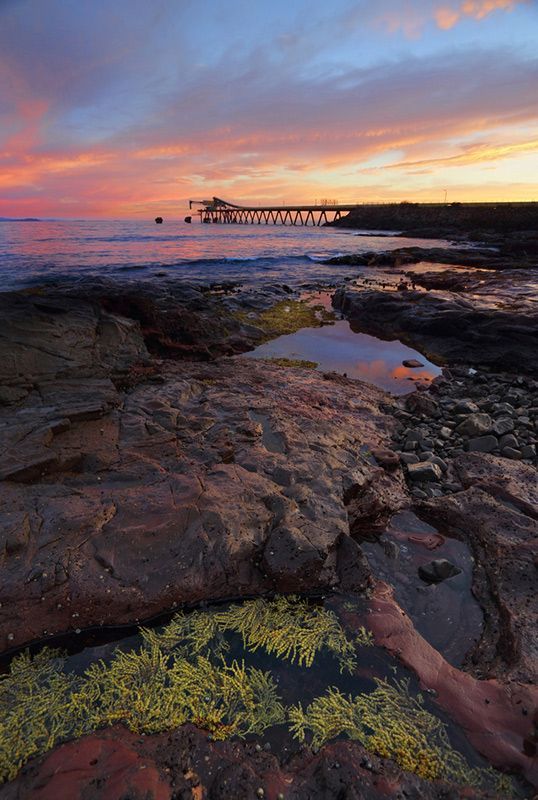 A Sunset Over a Rocky Beach with A Pier in The Background — Daves Drive U Anywhere in Shellharbour, NSW