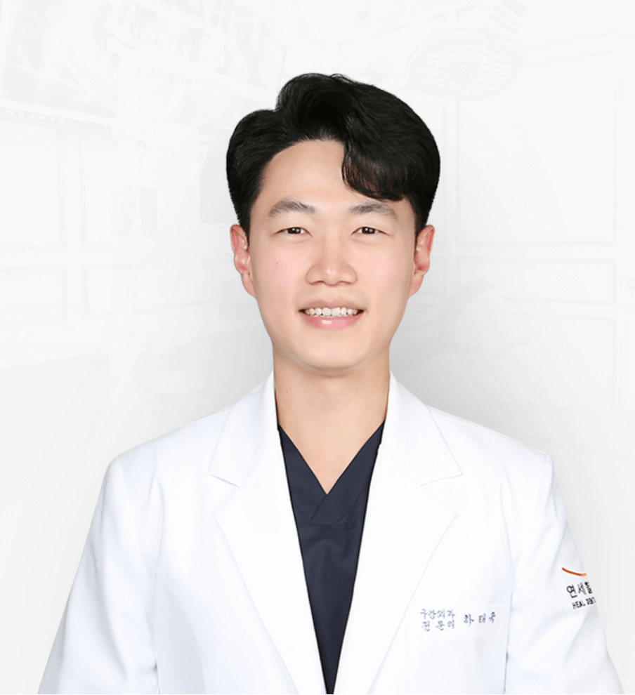 Smiling Asian man in a white coat, likely a doctor, looking at the camera.