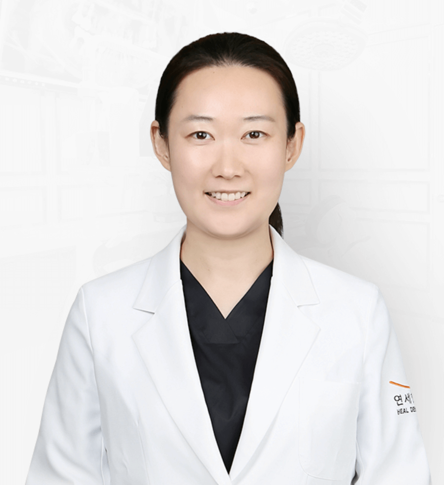 Woman in white lab coat smiling, presumably a doctor.