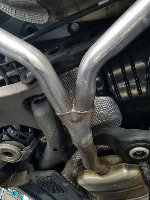 A close up of a exhaust pipe in a car | Ed Hanson's Muffler Service