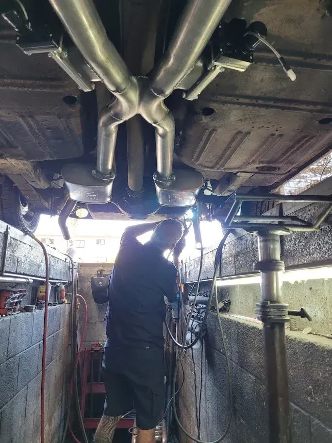 Mechanic working on under the car | Ed Hanson's Muffler Service