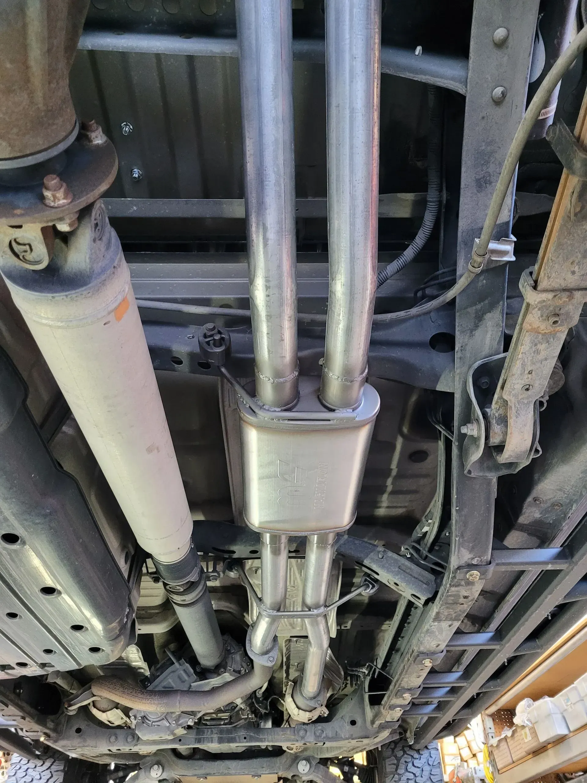 A close up of the underside of a truck with exhaust pipes | Ed Hanson's Muffler Service