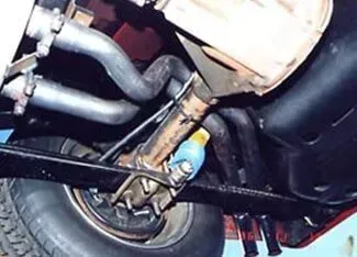 A close up of the underside of a car with a oil filter | Ed Hanson's Muffler Service