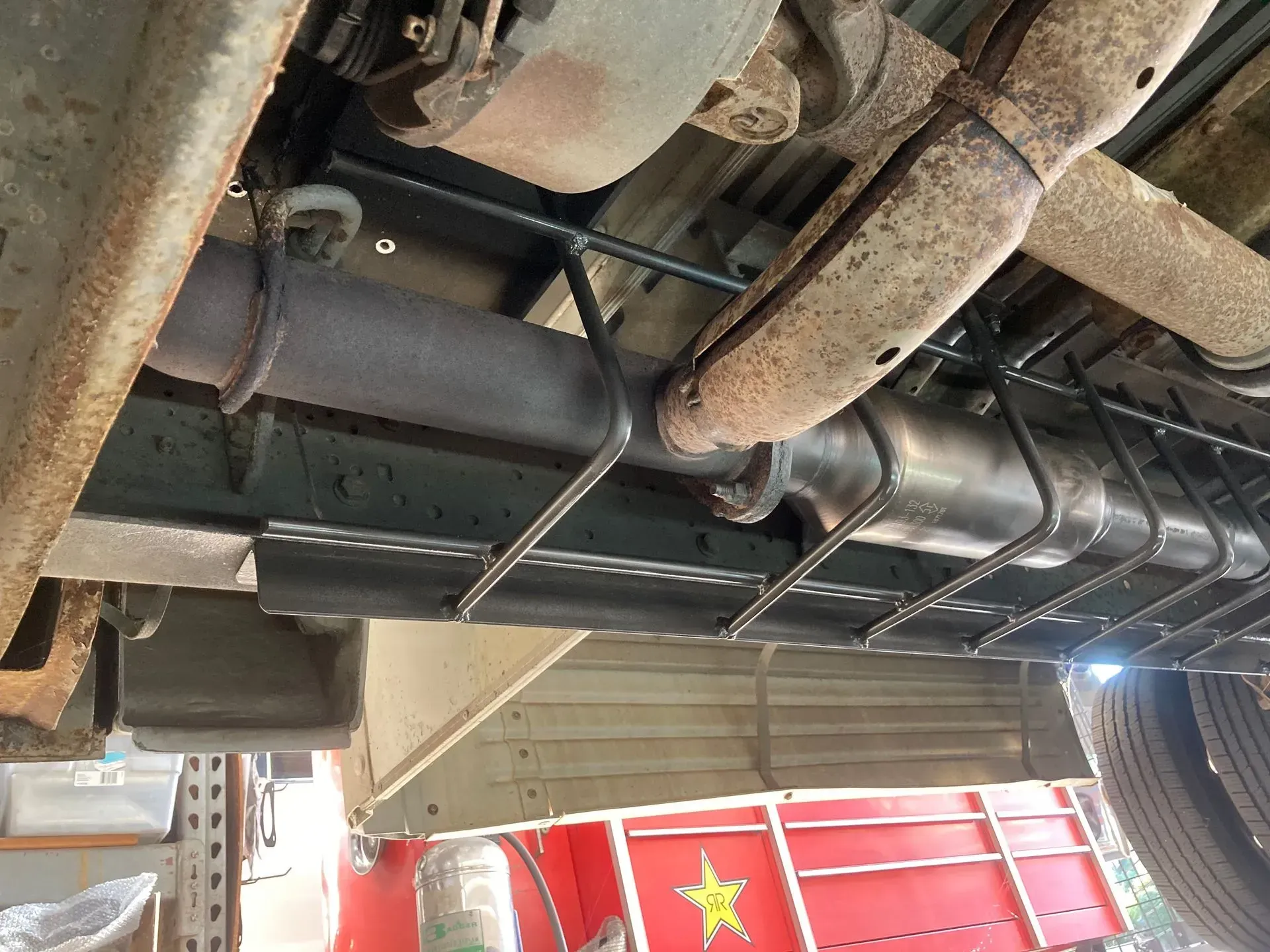A close up of the underside of a truck with a red star on it | Ed Hanson's Muffler Service