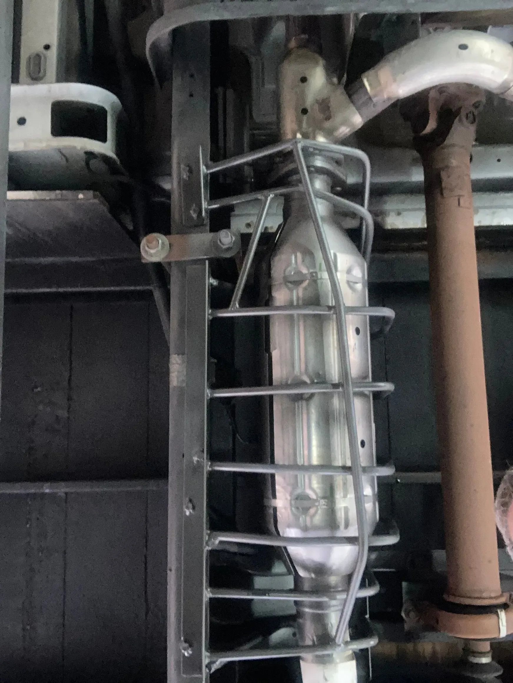 A close up of a exhaust pipe with a metal cage around it | Ed Hanson's Muffler Service