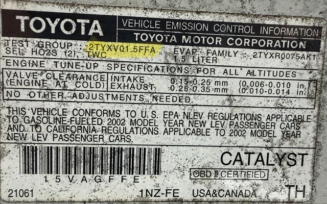 A Toyota vehicle emission control information sticker detailing engine specifications for a 2002 1.5-liter engine.