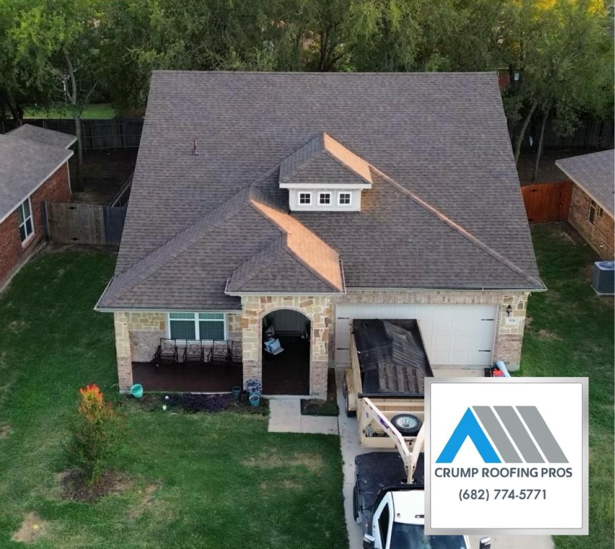 Aerial view of a house with a new shingled roof and a roofing company watermark in the corner
