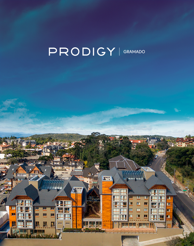Vista aérea dos edifícios de apartamentos Prodigy Drummond sob um céu azul brilhante.