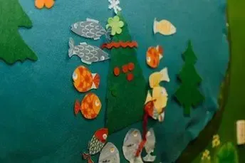 A fishing game with fish and trees made out of felt.
