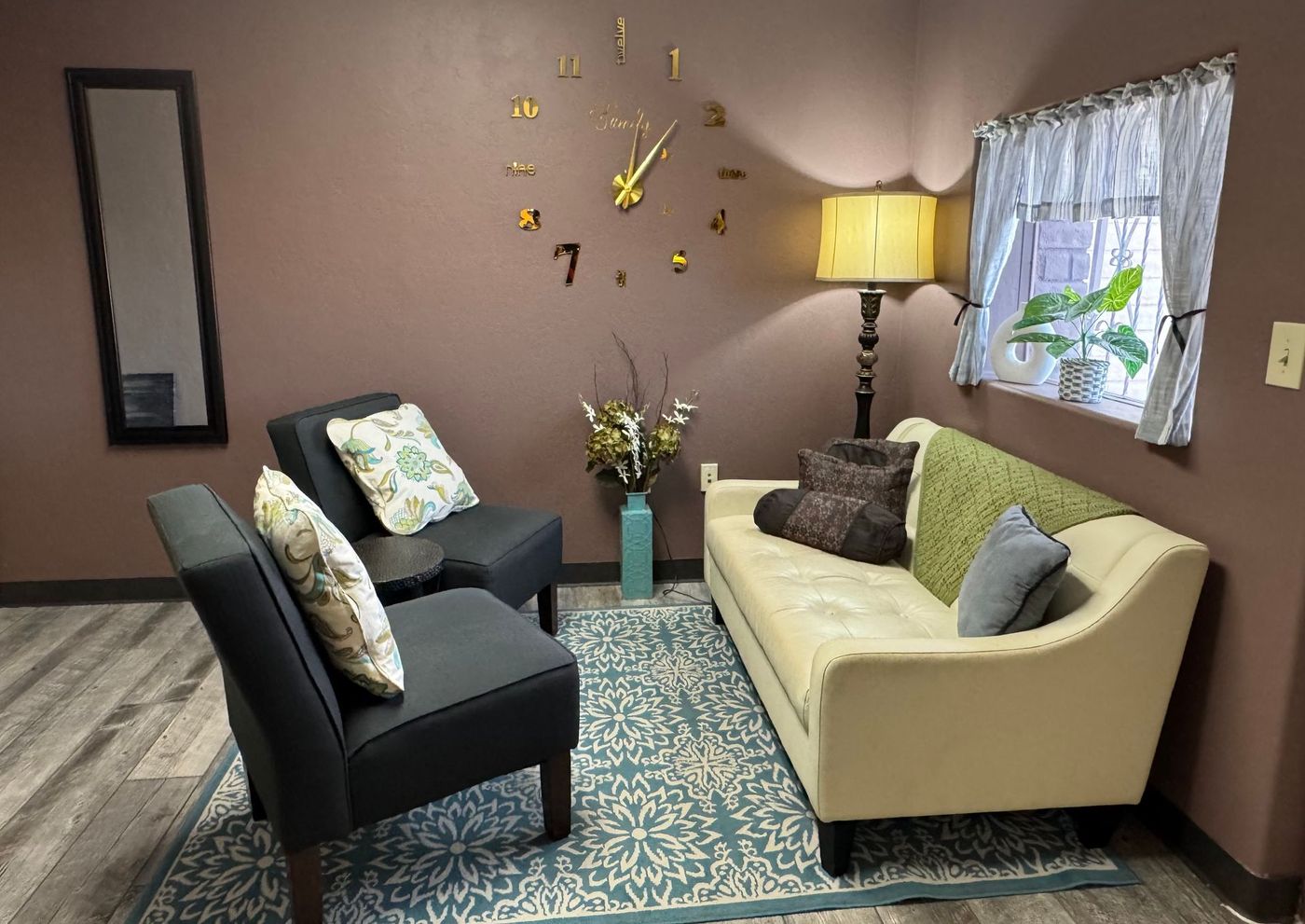There is a couch and two chairs in the room.