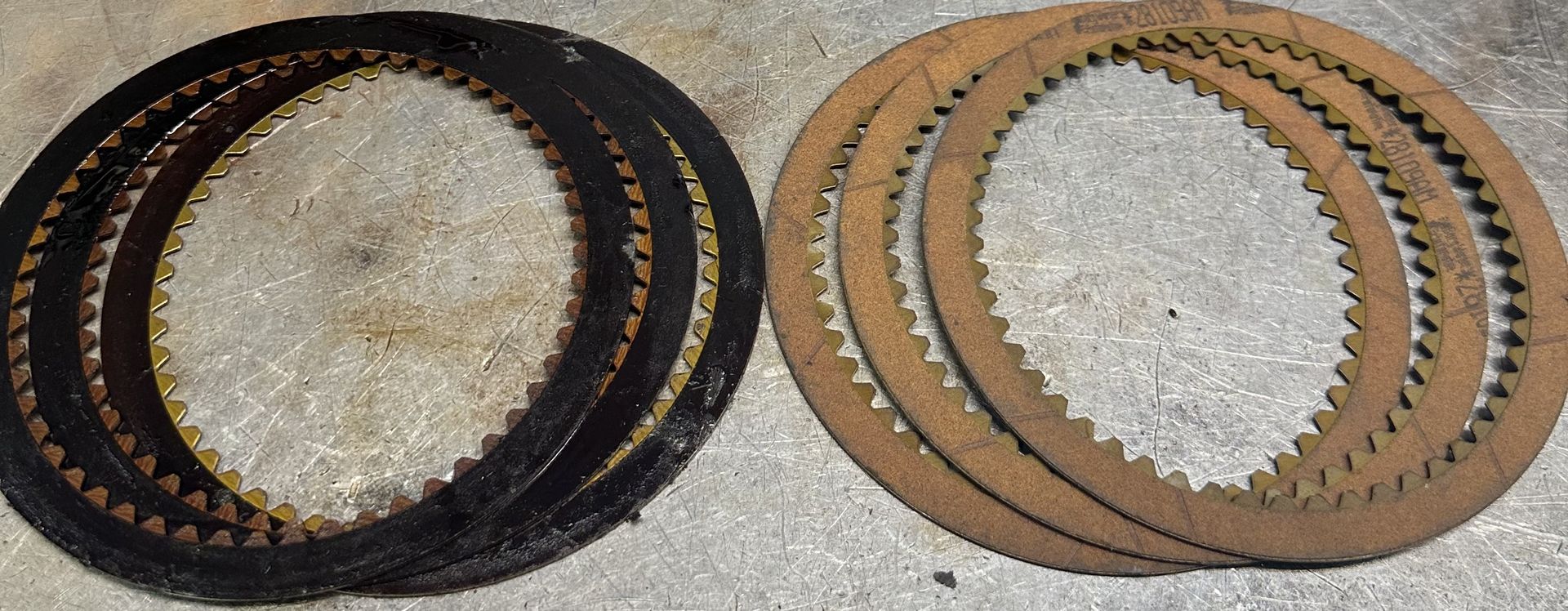 Burnt automatic transmission clutches compared with new transmission clutch plates