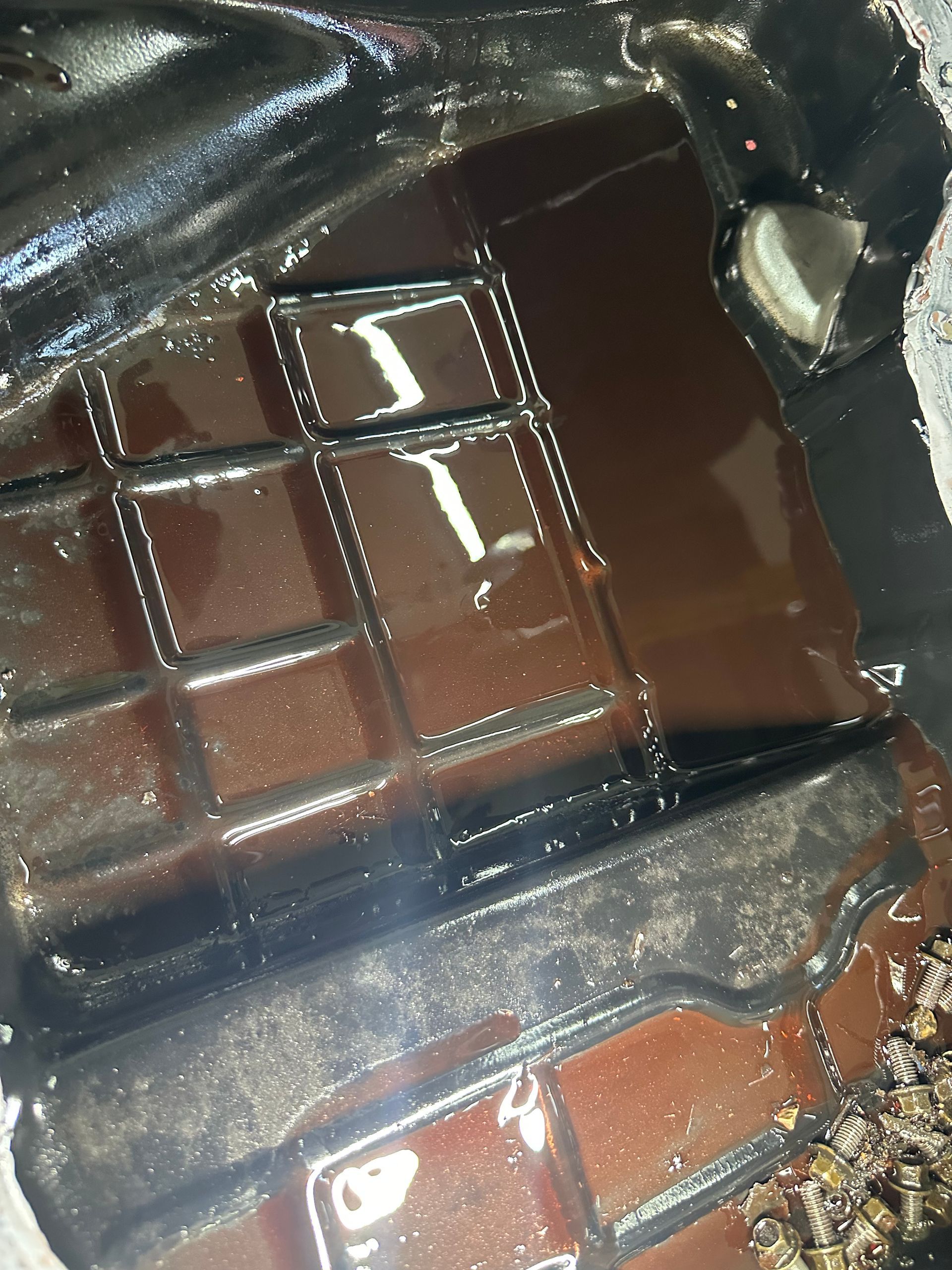 Clean transmission pan compared with a pan containing debris from an internal transmission failure