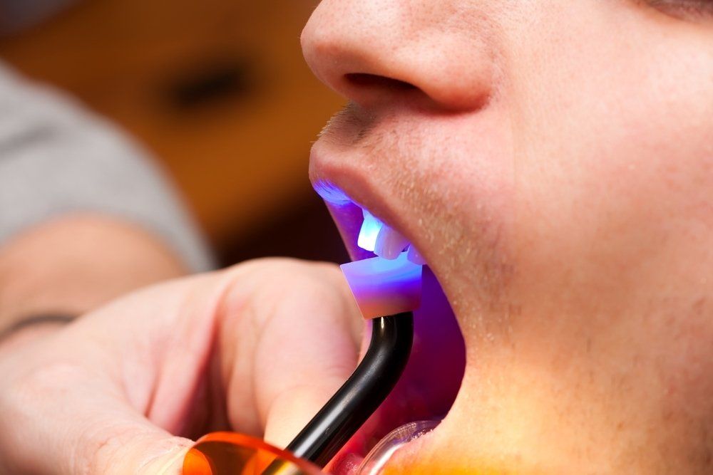 A man is getting his teeth examined by a dentist.