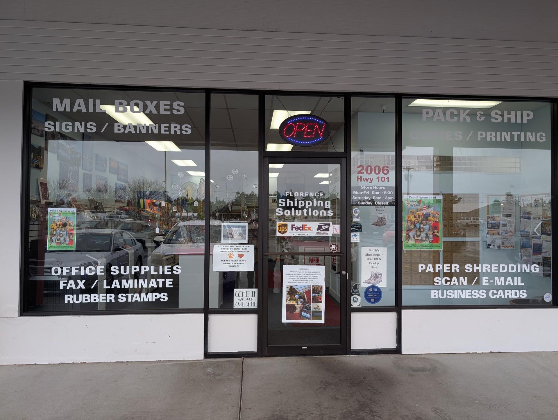 Storefront with signage for mailboxes, signs, office supplies, and packing/shipping services