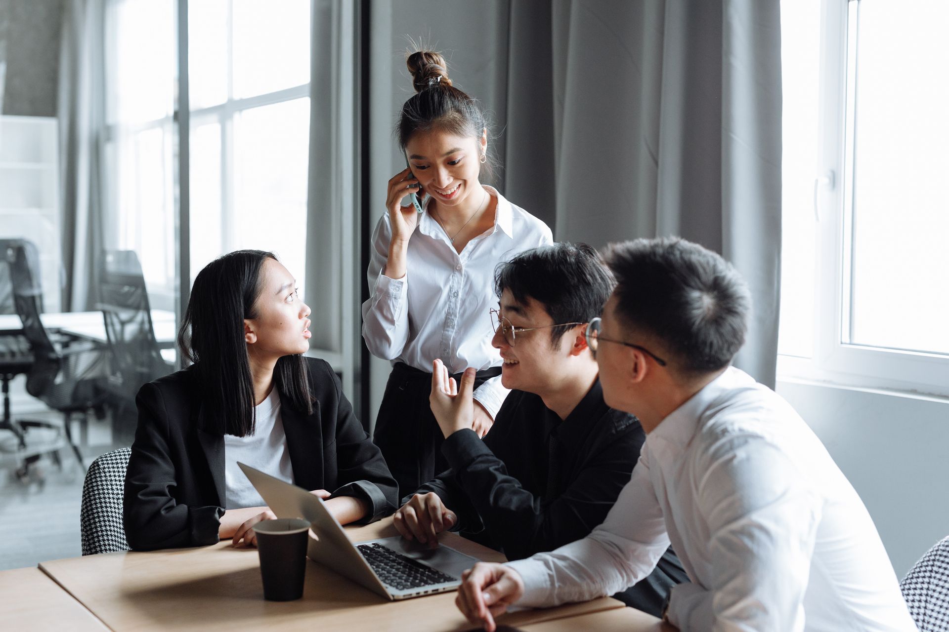 Young professionals collaborating at The Grid Co-Living workspace near Maka