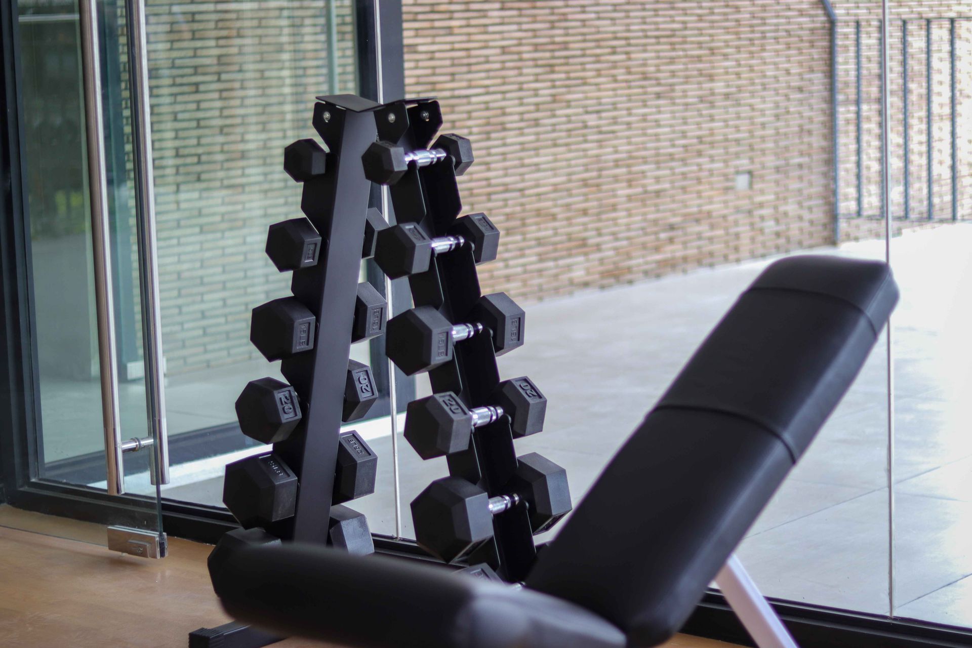 Hex dumbbell rack and adjustable bench in modern hotel gym