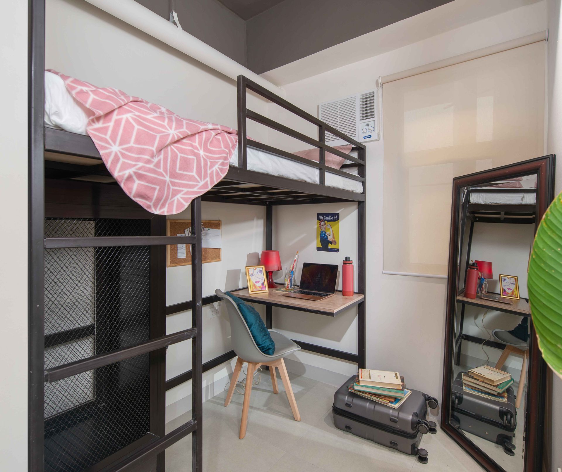 Cozy loft dorm room with desk, laptop, and pink bedding at The Grid Co-Livi