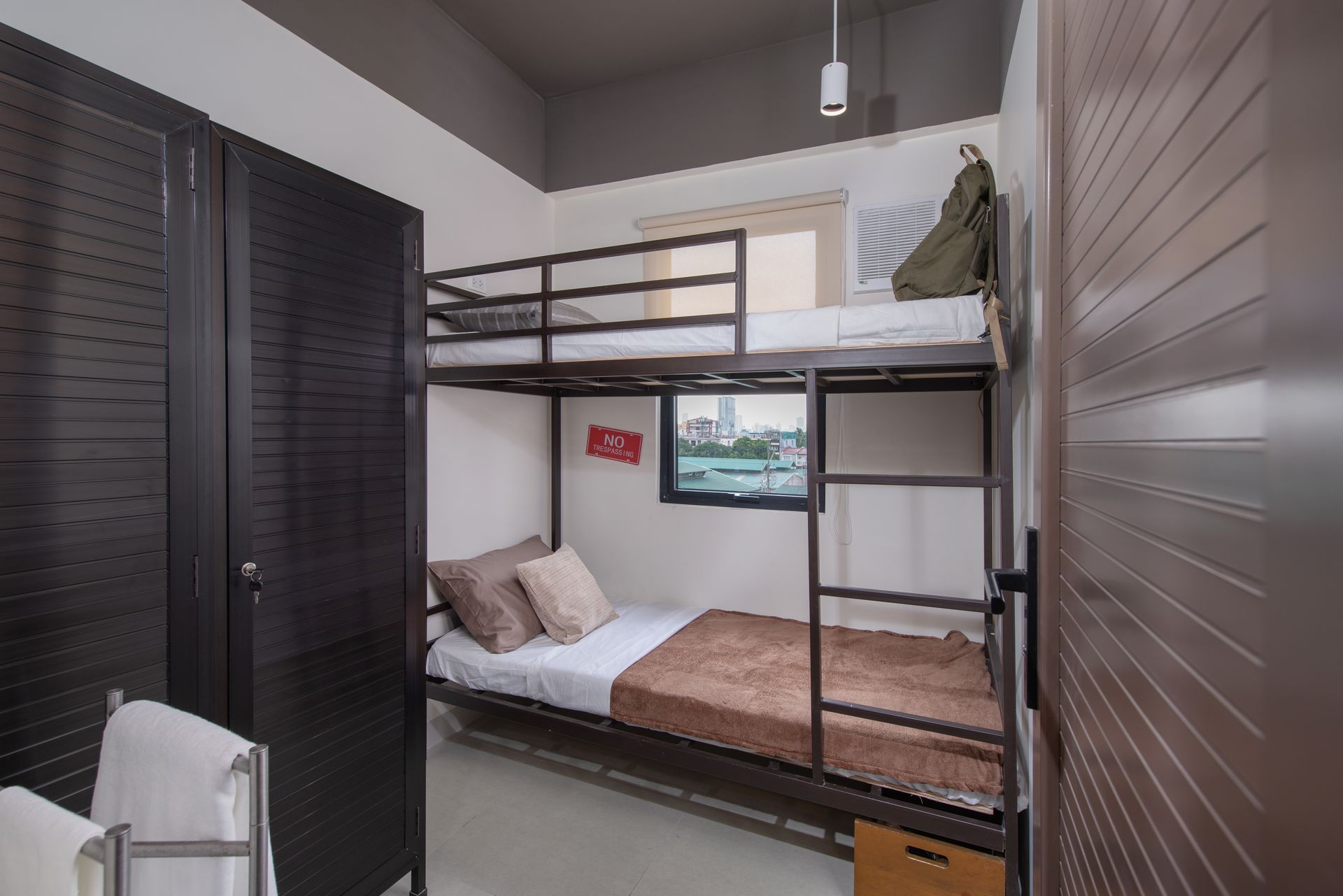 The Grid in Makati: A bedroom with two bunk beds and a window