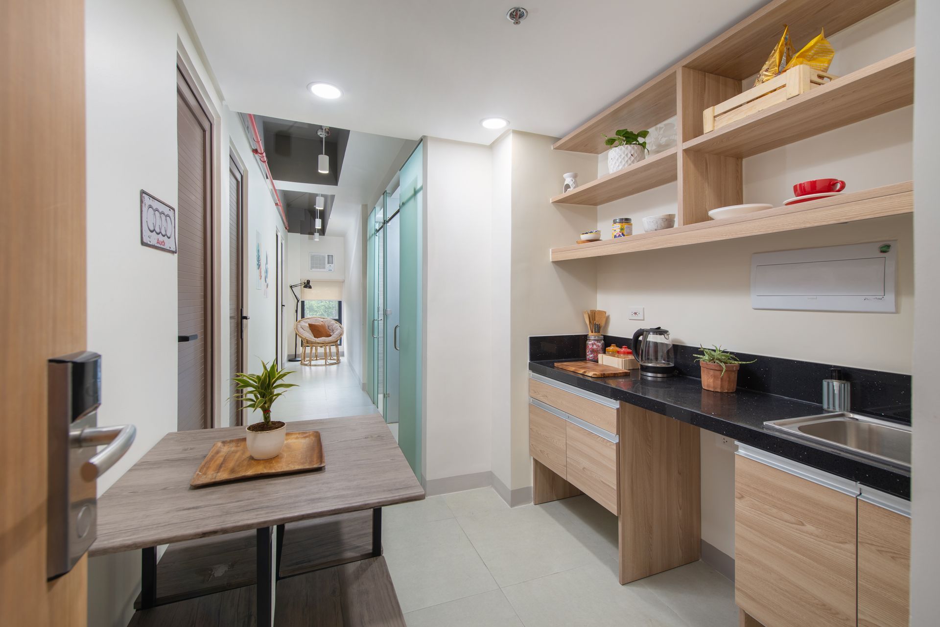 The Grid in Makati: A kitchen with a table and a sink in a hotel room.