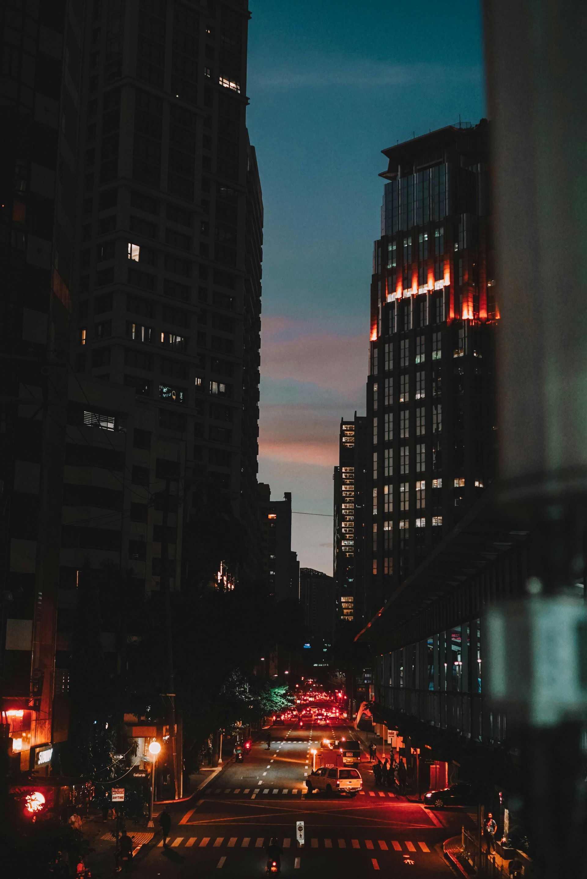 Makati CBD cityscape at dusk with glowing skyscrapers and busy street