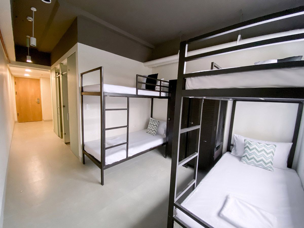 The Grid in Makati: There are three bunk beds in the room.