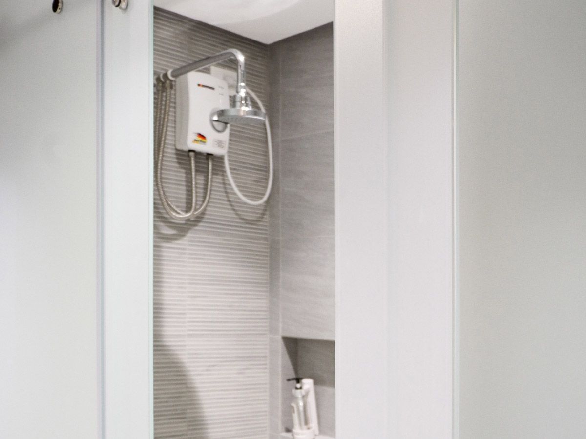 The Grid Makati: A bathroom with a shower head and a toilet.