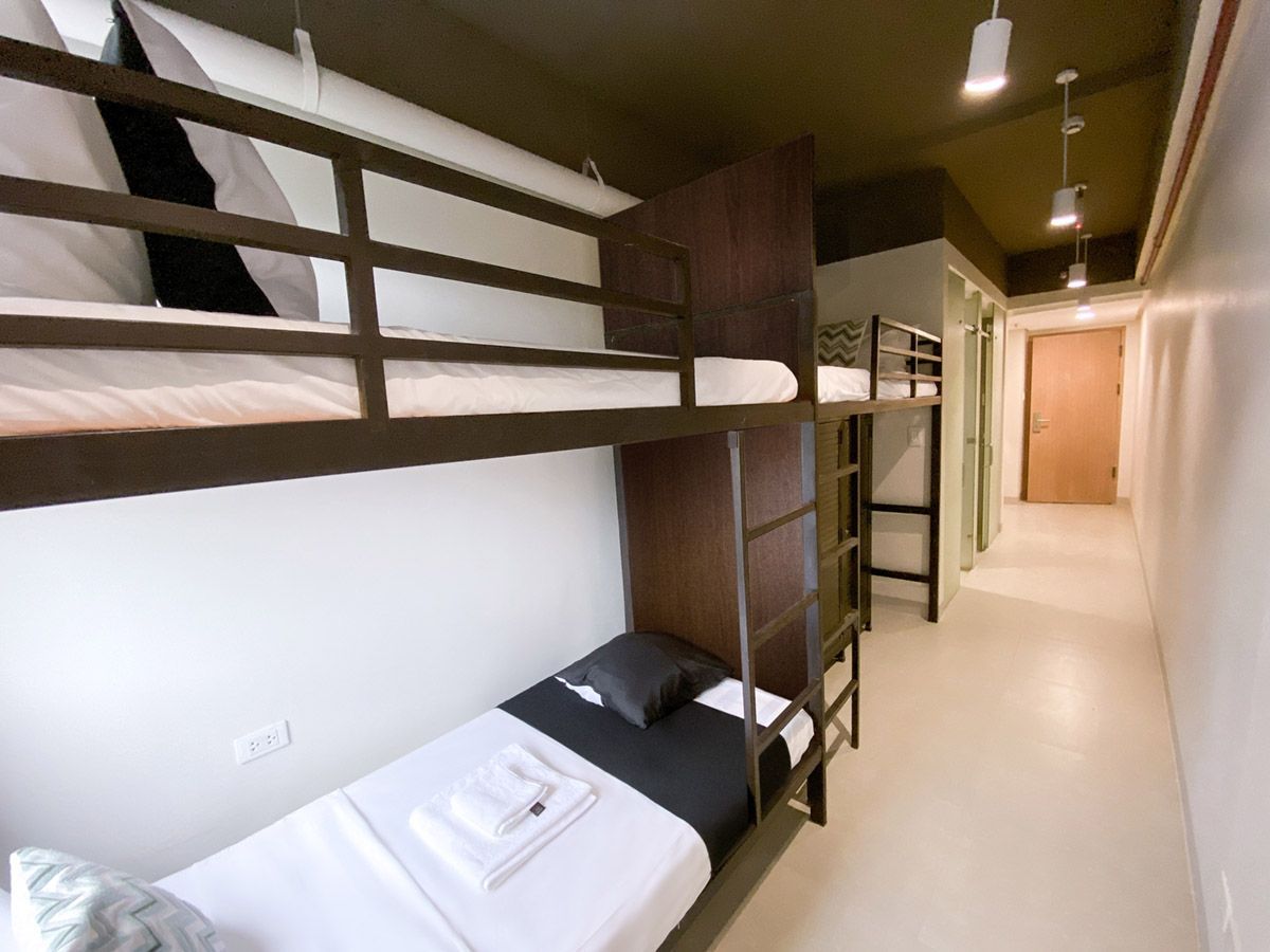 Triple Unit at The Grid in Makati. A room with bunk beds and a single bed