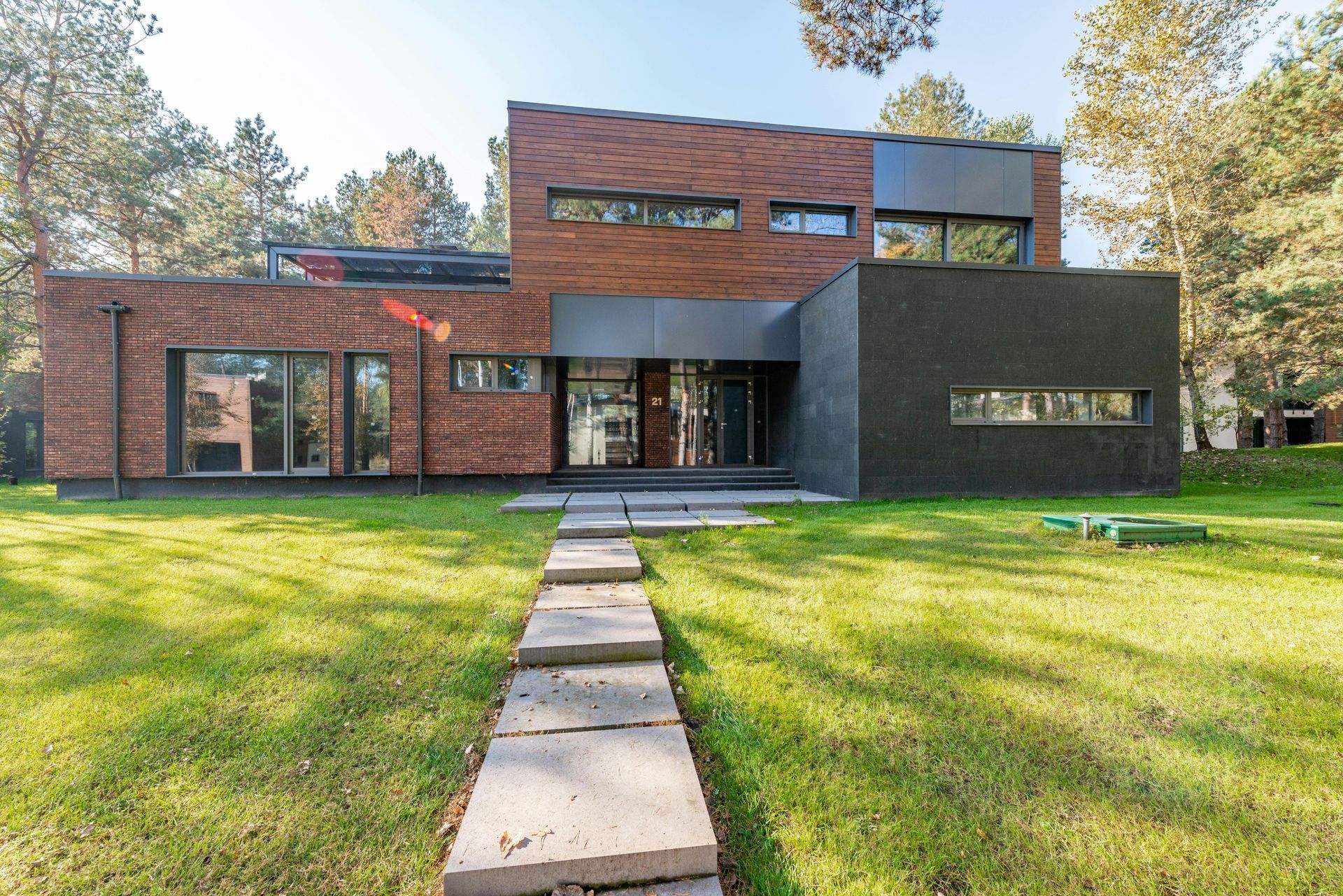 A modern brick house with a walkway leading to it