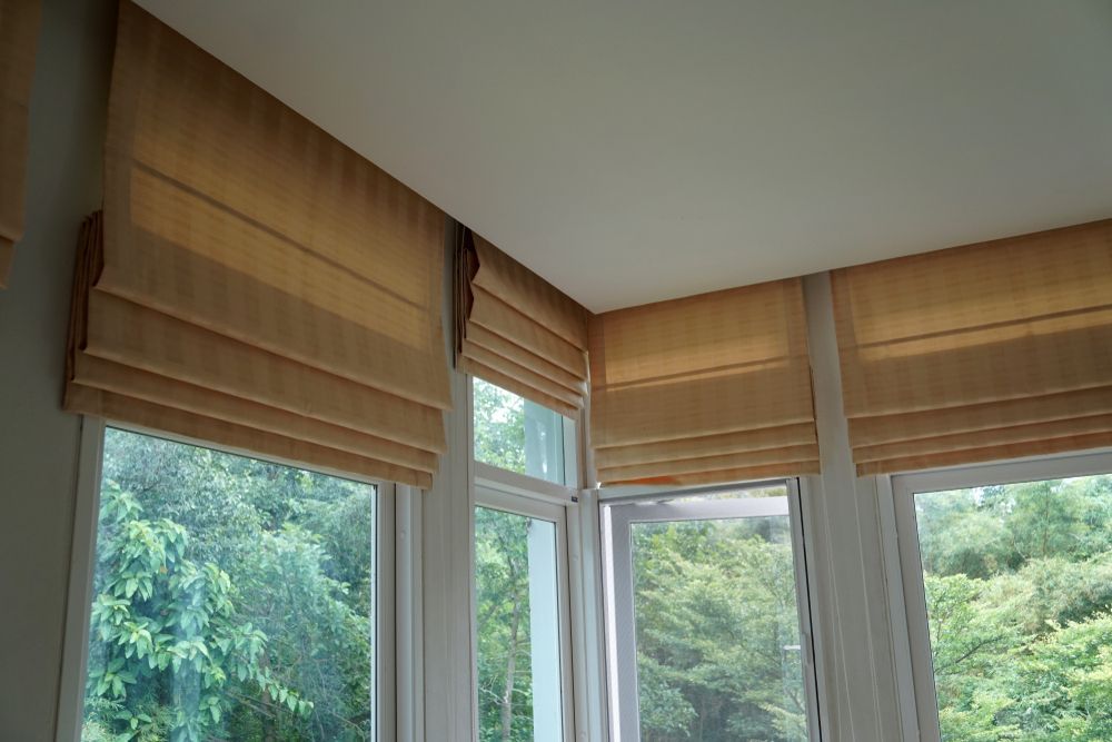 A Room With a Lot of Windows and Roman Blinds on Them — Curtain Haven & Blinds in Laurieton, NSW