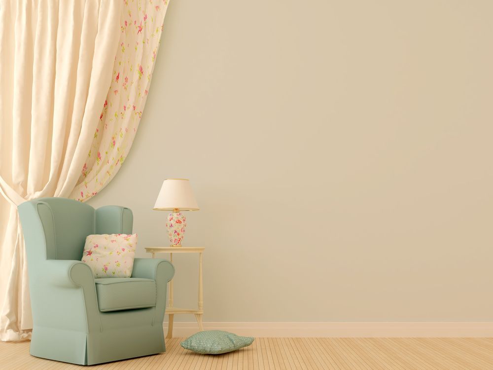 A Living Room With a Chair, Lamp, and Curtains — Curtain Haven & Blinds in Lake Cathie, NSW