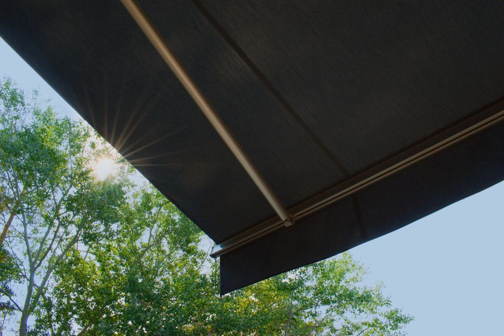 The Sun is Shining Through the Trees Behind the Awning — Curtain Haven & Blinds in Port Macquarie, NSW