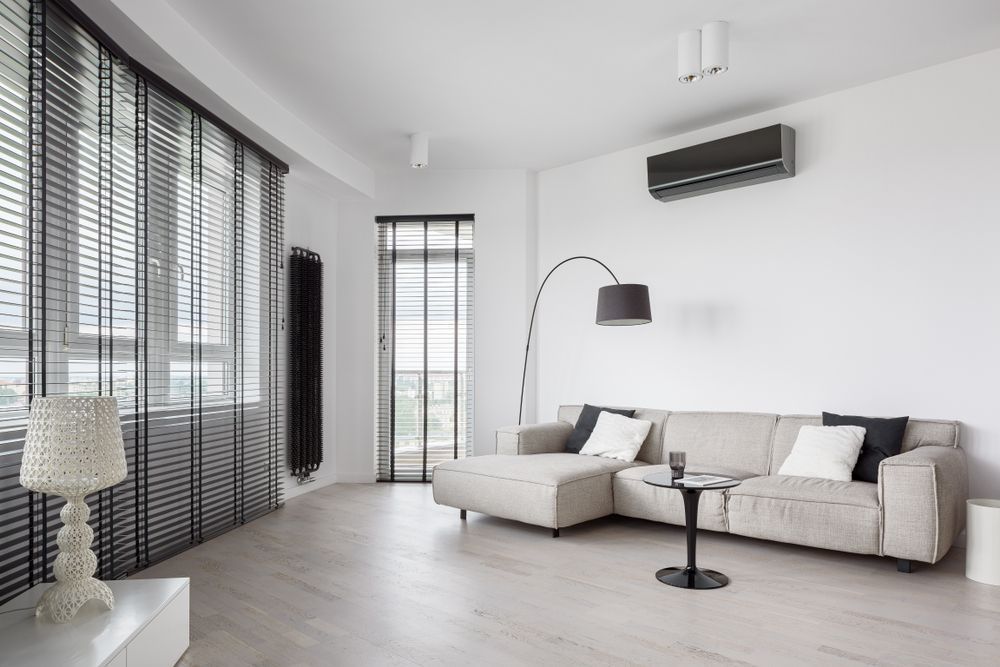 A Living Room With a Couch , Table , Lamp and Blinds — Curtain Haven & Blinds in Wauchope, NSW