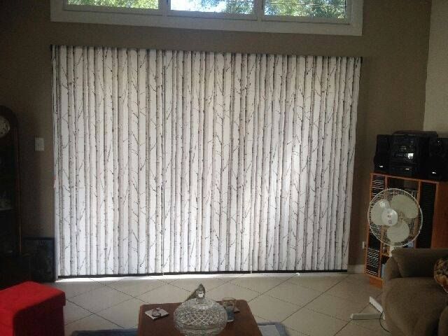 A Living Room With a Couch, Table, and Fan — Curtain Haven & Blinds in Laurieton, NSW