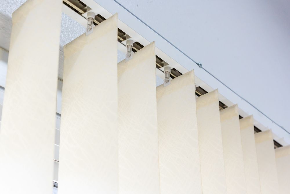 A Close Up of a Row of Vertical Blinds on a Window — Curtain Haven & Blinds in Port Macquarie, NSW
