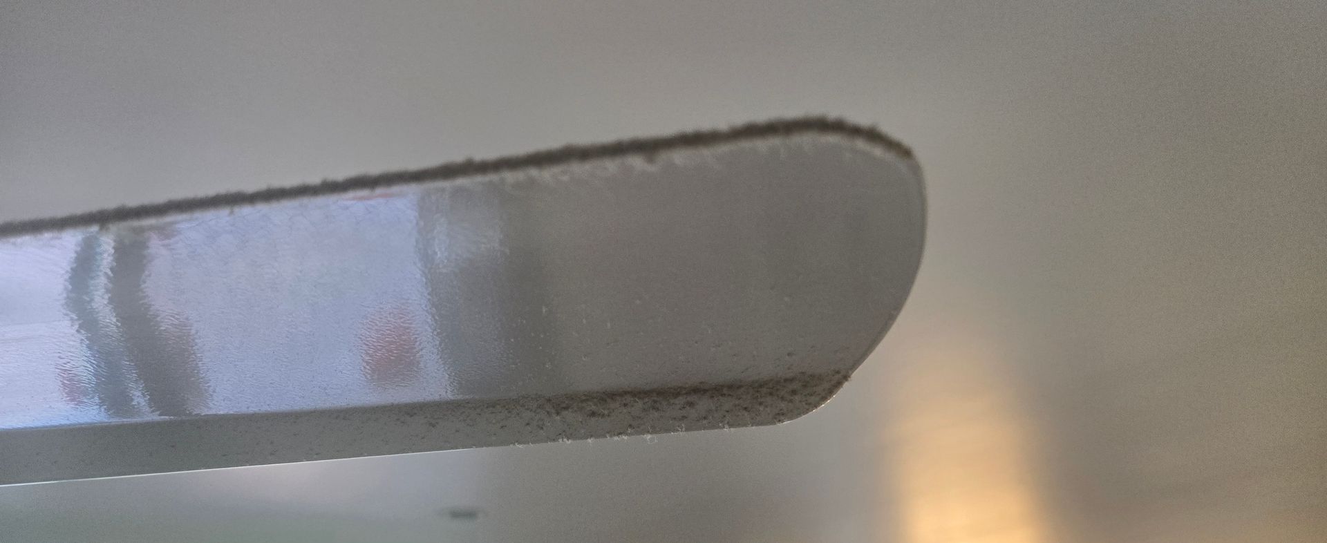 A dirty white fan covered in dust and dirt