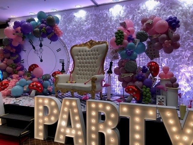 “Before and after of a corporate event entrance transformed with colorful balloon décor