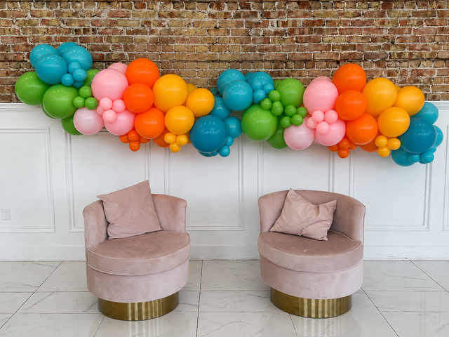 Design illustration of a colorful 12-foot organic balloon garland above two chairs