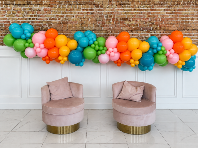Design illustration of a colorful 18-foot organic balloon garland above two chairs