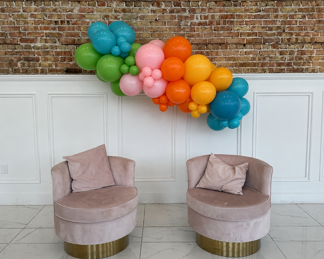 Design illustration of a colorful 6-foot organic balloon garland above two chairs