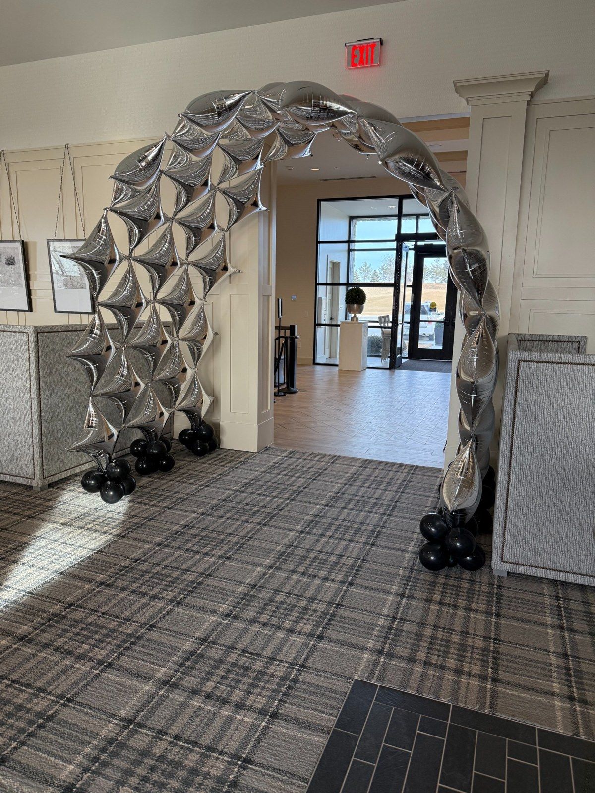 Silver balloon installation framing a hallway entrance