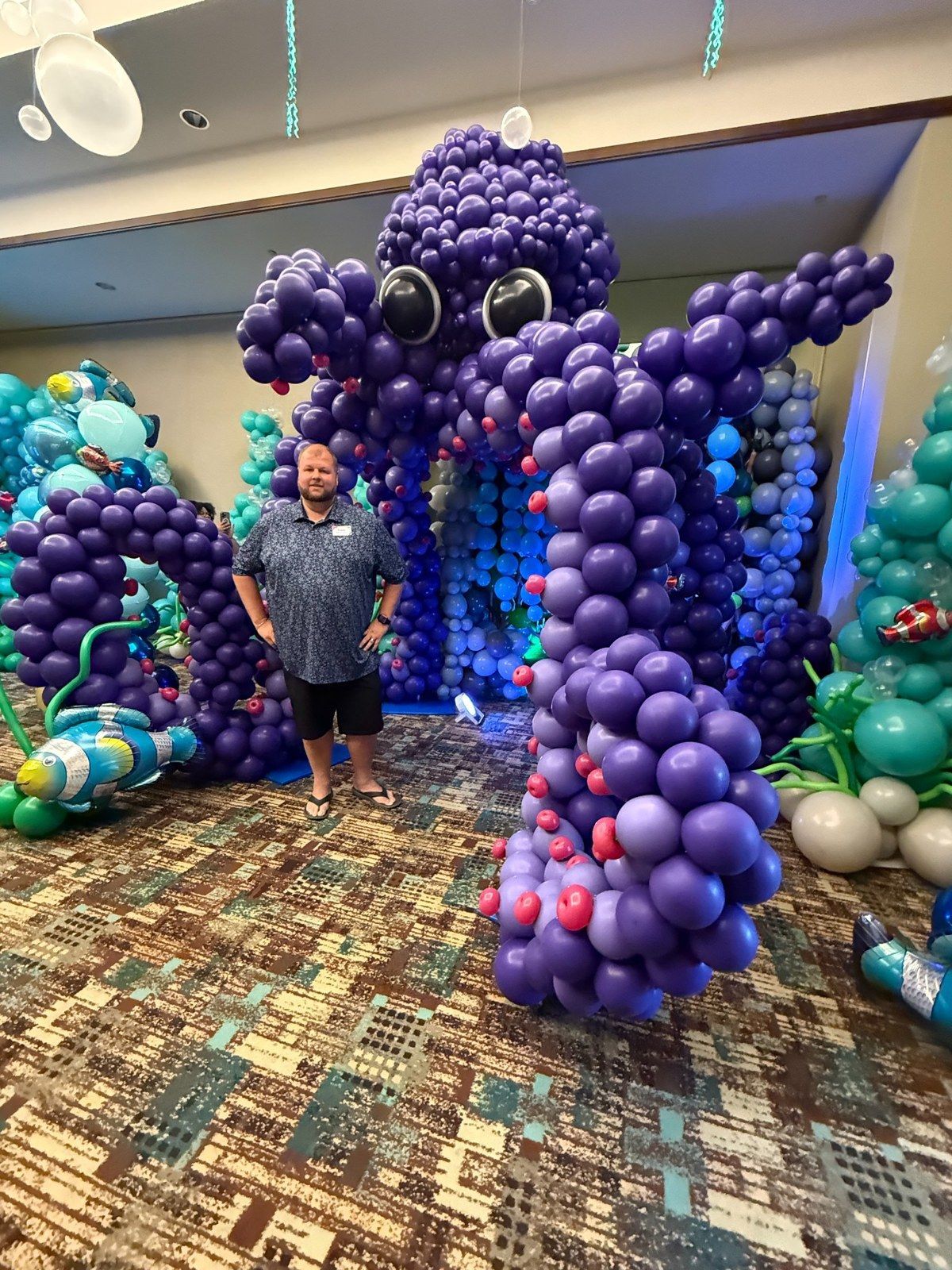 Giant purple balloon octopus sculpture displayed at an indoor event