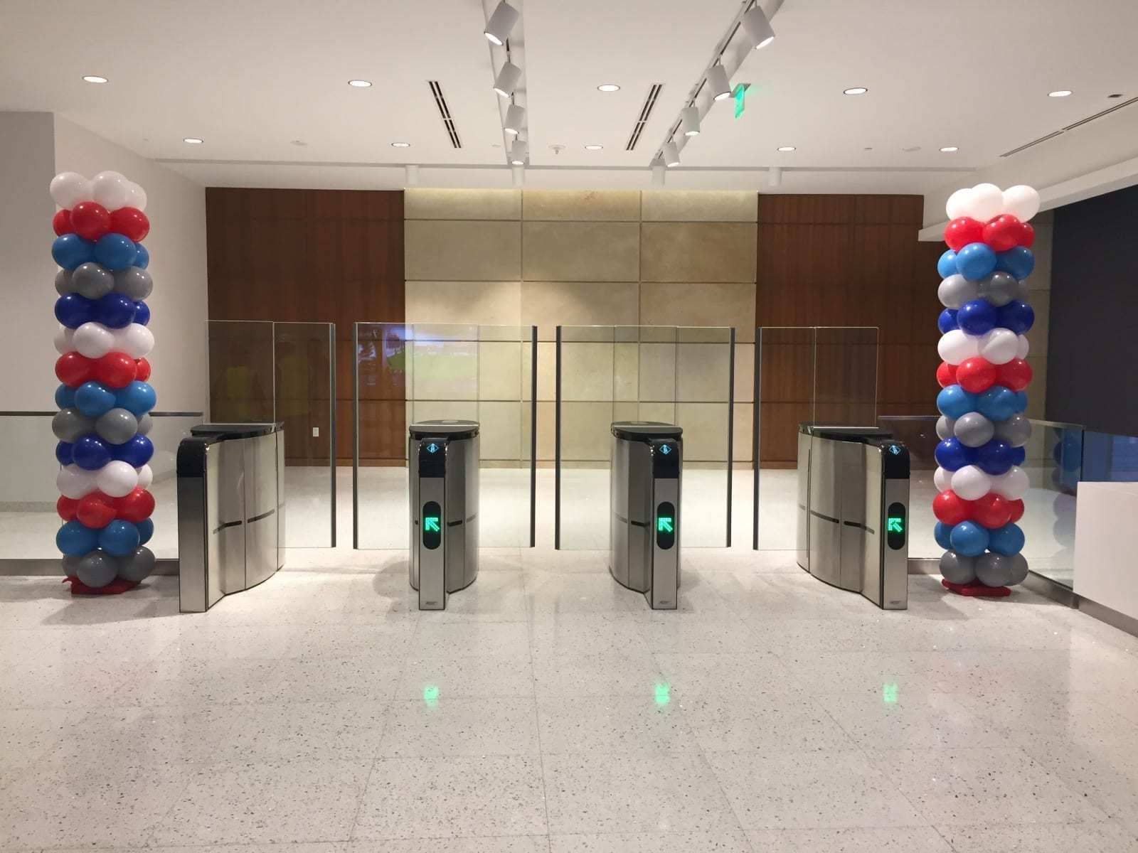 Multicolor classic balloon columns beside office lobby entry gates