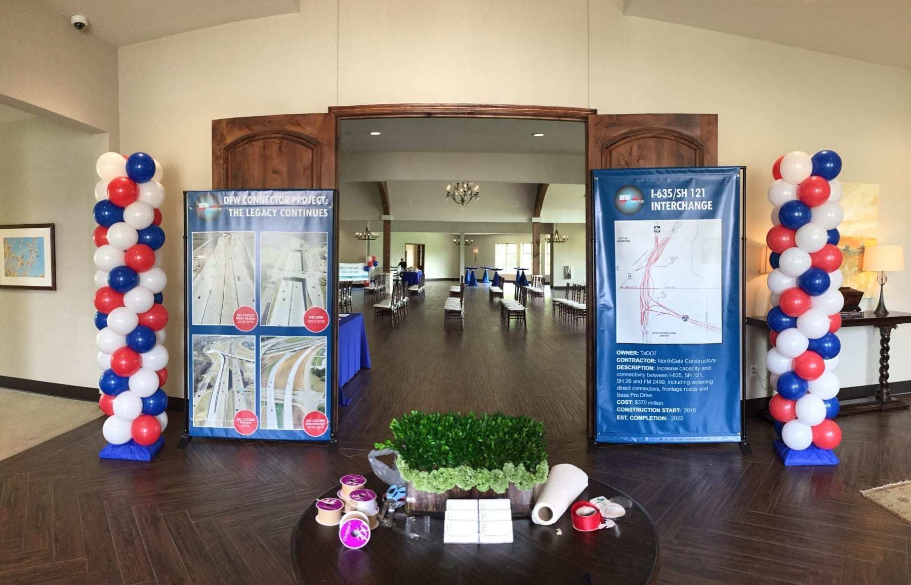 Red white and blue spiral balloon columns framing a corporate event entrance