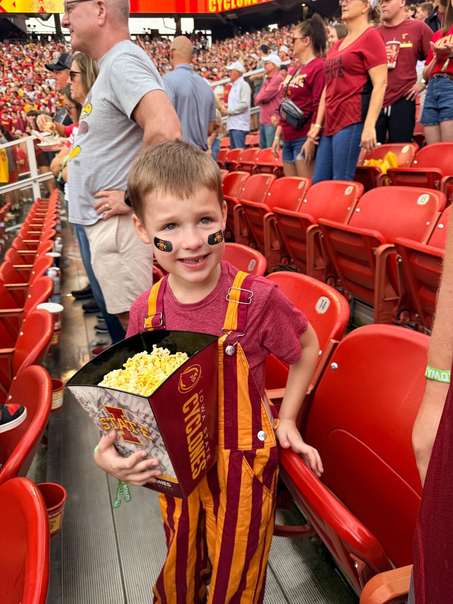 Hudson enjoying popcorn at a football game